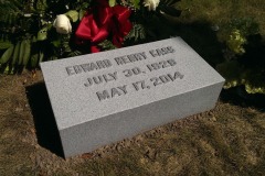 Photo of memorial grave marker with hand carved lettering