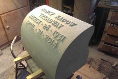Photo of memorial grave marker with hand carved lettering
